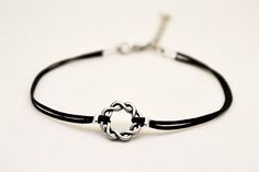 Karma anklet - black anklet with a silver tone braided circle charm. The color of the cord is black and it is made of waxed cotton. The circle charm is made of alloy. The anklet come with an extension so it is adjustable. Closure: clasp. You can request a thread in a different color from the colors shown in the last picture.The anklet is 8 1/2" (21.5cm) long plus a 1 1/2" (4cm) extension. If you would like a different length, write your request at checkout and we will make it for youThis anklet Silver Braided Bracelets With Adjustable Cord, Casual Silver Anklets For Gifting, Casual Silver Anklets As Gift, Casual Silver Anklets For Gifts, Minimalist Silver Braided Bracelet With Adjustable Cord, Silver Minimalist Braided Bracelet With Adjustable Cord, Black Sterling Silver Bracelets With Adjustable Cord, Sterling Silver Black Bracelet With Adjustable Cord, Black Sterling Silver Bracelet With Adjustable Cord