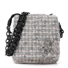 This is the authentic CHANEL Tweed Camellia Messenger in Multicolor. This messenger bag is crafted of grey and white tweed with black leather piping trim. The bag features a braided black leather and chainlink shoulder strap and a crossover flap that opens to a front zippered pocket and a black Chanel logo fabric interior with a second zippered pocket. Classic Phones, Pop Stitch, Chanel Crossbody, Chanel 19, Quilting Frames, Chanel Tweed, Denim Quilt, Chanel Shoulder Bag, White Tweed