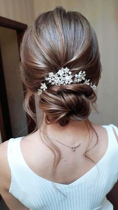 a woman wearing a hair comb with flowers in it