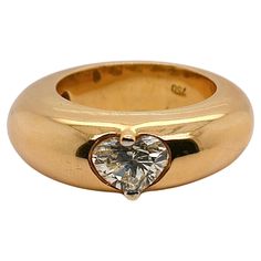 This exquisite 18-carat gold ring, weighing 16.70 grams, is a true masterpiece of jewelry design. The ring boasts a domed shape that exudes luxury and elegance, making it a standout piece for any collection. Thoughtfully crafted, the interior of the ring is open, allowing the skin of the finger to breathe and providing exceptional comfort for all-day wear. The highlight of this magnificent ring is a stunning heart-shaped diamond of G color, totaling an impressive 1 carat. This exquisite diamond not only adds a touch of brilliance but also elevates the ring to a new level of sophistication and allure. Perfect for any special occasion, this ring is a testament to timeless beauty and exquisite craftsmanship. Gold Thumb Rings, French Modern, Heart Shaped Diamond, Thumb Rings, Diamond Gold, The Ring, 1 Carat, Timeless Beauty, Gold Ring