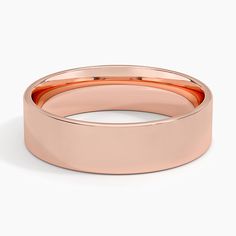 a rose gold wedding ring on a white background