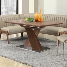 a wooden table sitting on top of a gray rug