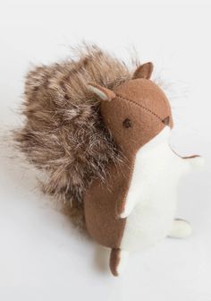 a brown and white stuffed animal with fur on it's head