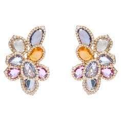 18 Karat Yellow Gold 13.56 Carat Multi-Sapphire and Diamond Cocktail Stud Earrings This illustrious rainbow multi-sapphire and diamond stud earring is exquisite. The uneven mix shape rose cut multi-sapphires are skillfully placed one over the other and angled marvelously, as they distinctly highlight each collate. The differing layers enhance the multi-sapphires all the way while the single row cluster of pave set diamonds border each sapphire and profoundly make it a modern and uniquely contemp Multi Sapphire Earrings, Multi Sapphire Jewellery, Saphire Jewelry, Egyptian Inspired Jewelry, Sapphire Jewellery, Diamond Stud Earring, Multi Coloured Necklaces, Contemporary Earrings, Multi Sapphire