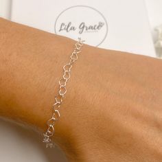 "Super cute sterling silver bracelet made from a heart link chain. Perfect as a gift or treat yourself, the bracelet is adjustable in size, choose your maximum size and then when worn make it a smaller fit by attaching the clasp to any link on the bracelet. Optional jewellery box, perfect if buying as a gift. WHAT YOU GET Bracelet Jewellery Card and Resealable Clear Bag Optional Jewellery Box MEASUREMENTS Each heart link is approx 5mm in size SIZE ONE - max size is 6\" SIZE TWO - max size is 7\" Silver Heart Charm Bracelet For Friendship, Sterling Silver Bracelet For Her, Valentine's Day Gift, Silver Heart Bracelet Gift, Sterling Silver Heart Bracelet With Adjustable Chain, Minimalist Sterling Silver Heart Bracelet For Mother's Day, Adjustable Silver Heart Bracelet For Valentine's Day, Heart-shaped Charm Bracelet For Birthday Gift, Dainty Silver Bracelets For Valentine's Day, Silver Dainty Bracelet For Valentine's Day