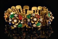 "This is a very beautiful, vintage and unique JADE GLASS FAUX PEARLS DIAMOND RHINESTONE c. 1940 bracelet. The idyllic bracelet has fantastic shape with flowers, faux pearls, jade glass, carnelian glass, lapis glass cabochons and diamonds rhinestone and gold tone metal in fantastic quality. It measures 6 1/2\" x 3/4\". The bracelet has a very extravagant and elegant feel to it and is in very good condition. 0.6 D120815016" Vintage Jeweled Bracelets For Wedding, Vintage Multi-stone Bracelets Gift, Vintage Multi-stone Wedding Bracelets, Vintage Wedding Bracelets With Multi-stone, Vintage Multi-stone Bangle Bracelet, Pearl Diamond, Flower Bracelet, Chain Link Bracelet, Gold Tone Metal