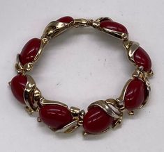 "Beautiful Art Deco Crown Trifari Gold Tone Red Lucite Links Bracelet pre/owned condition measures 7 1/4\" length by 5/8\" width." Adjustable Red Oval Bracelet, Adjustable Red Oval Bracelets, Red Costume Jewelry Bracelets As Gift, Vintage Adjustable Red Bracelets, Vintage Red Adjustable Bracelets, Vintage Red Adjustable Bracelet, Retro Red Bracelet Jewelry, Red Retro Bangle Jewelry, Vintage Red Bracelet As A Gift