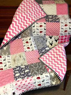 a pink and gray quilt sitting on top of a wooden chair