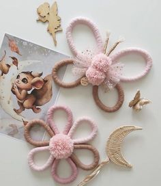 three pairs of pink hair clips sitting on top of a table next to an album