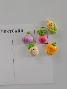 small plastic fruits and vegetables on a postcard