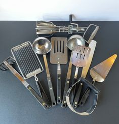 an assortment of kitchen utensils on a table