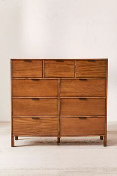 a large wooden dresser sitting on top of a white floor