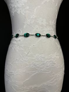 High quality silver colour metal chain belt with Emerald Green Jewel Stones.  Beautiful Emerald Green Jewels make this belt stunning to add to any outfit or swimwear accessory. Set on a silver metal base to set off this belt.  Exclusively designed by FAN Design, this belt is made to a wide range of sizes. Matching necklace also available. Hand crafted to sizes.   Choose your waist size in inches, all belts will come with an extra 12 inch hanging chain Tap into the hottest new trend with chain be Silver Crystal Waist Chain For Party, Elegant Silver Chain Metal Belt, Formal Silver Chain Belt, Silver Metal Body Chain With Rhinestones, Elegant Silver Crystal Waist Chain, Silver Crystal Chain Belt For Party, Elegant Silver Chain Belt With Rhinestones, Elegant Silver Crystal Chain Belt, Elegant Silver Body Chain With Rhinestones