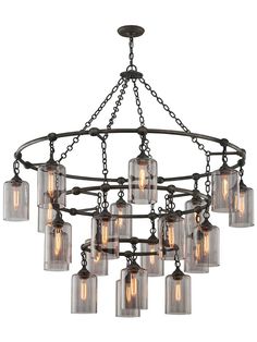 a chandelier with many glass jars hanging from it's arms and bottom