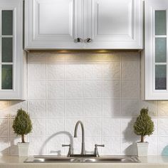 a kitchen with white cabinets and a sink