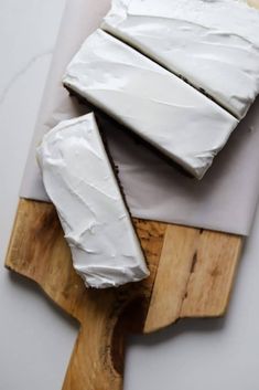 two slices of cake sitting on top of a cutting board