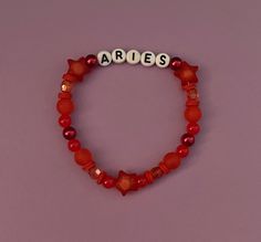 a red beaded bracelet with the word ables spelled out in white letters on it