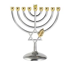 a silver menorah with five candles and an olive branch on the top, in front of a white background