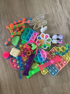 a pile of plastic toys sitting on top of a wooden floor