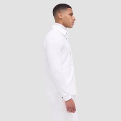 Made from a luxurious soft-touch knit fabric, this performance shirt jacket offers exceptional comfort and style. It features a point collar, full snap closure, ribbed cuffs, zippered side pockets, and sleek nylon trimming. Combining practicality with modern sophistication, this shirt jacket is a great choice for both casual and activewear. Classic White Outerwear With Spread Collar, Modern Track Jacket With Ribbed Cuffs, Modern Long Sleeve Track Jacket With Ribbed Cuffs, Workwear Track Jacket With Ribbed Collar And Long Sleeves, Casual White Outerwear With Spread Collar, Business Outerwear With Ribbed Cuffs And Long Sleeves, Classic Long Sleeve Sport Coat With Ribbed Cuffs, Modern White Outerwear With Concealed Placket, Business Casual White Outerwear With Button Cuffs