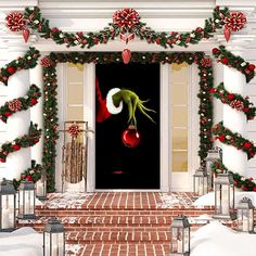 a white door decorated for christmas with poinsettis and wreaths