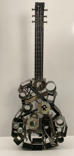 a guitar sculpture made out of metal parts