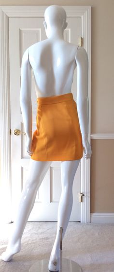 "This vintage Moschino skirt is in his iconic taxi cab/school bus yellow. Fully lined in yellow rayon. Side zipper with self button. Front and back shaping seams. Measurements - Waist - 27' Hips - 36\" Length - 18\"" Chic Fitted Yellow Pencil Skirt, Chic Yellow Fitted Pencil Skirt, Chic Fitted Yellow Skirt, Retro High-waist Fitted Mini Skirt, Retro Fitted High Waist Mini Skirt, Retro Fitted High-waist Mini Skirt, Fitted High Waist Retro Mini Skirt, Retro High Waist Fitted Skort, Retro High-waist Fitted Skort