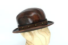 Brown Leather Brimmed Fedora, Fitted Leather Fedora Hat, Fitted Leather Hat With Curved Brim, Fitted Brown Leather Fedora, Fitted Leather Hat With Short Brim, Fitted Leather Top Hat With Short Brim, Fitted Leather Top Hat With Flat Brim, Vintage Leather Fedora With Flat Brim, Vintage Leather Top Hat With Flat Crown