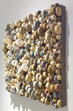 a wall sculpture made out of wooden discs