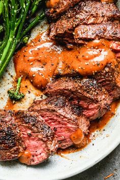 steak with sauce and asparagus on a plate