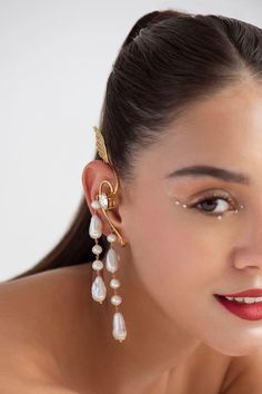 22k gold plated, 925 silver base ear cuffs handcrafted with carved work wing details, white pearls, Swarovski stones embellishment and drop long tassel details. - Aza Fashions Elegant Gold Plated Silver Ear Cuff, Elegant Gold Plated Ear Cuff For Formal Occasions, Yellow Gold Plated Ear Cuff For Wedding, Luxury Gold-plated Clip-on Jewelry, Luxury Wedding Ear Cuff For Pierced Ears, Luxury Gold Formal Ear Cuff, Luxury Ear Cuff For Evening, Luxury Clip-on Pearl Earrings For Party, Luxury Gold Ear Cuff For Wedding