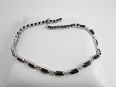 A beautiful black and white beaded choker necklace. In silver tone metal with a lovely rhinestone encrusted hook clasp. Measures 14 in and is high end quality! I imagine it is a unsigned Weiss. Feather Cuff Bracelet, Pastel Necklace, Beaded Choker Necklace, Topaz Stone, Hook Clasp, Gorgeous Bracelet, Choker Necklaces, Beaded Choker, Clear Rhinestones