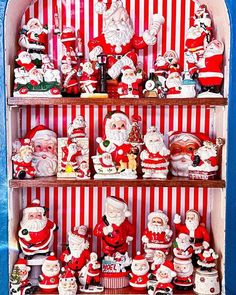 santa claus figurines are displayed on shelves