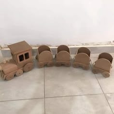 a group of wooden toys sitting on top of a cement floor