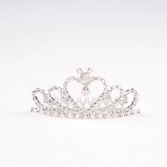 This is a high quality Mouse Ear Rhinestone Mini Tiara. This is made from silver plated alloy. The metal comb is attached and easy to use. Here is a link to our Business Insider video showcasing some of our Princess Tiaras: https://youtu.be/GNTaVqAsDkw The crown measures 3.5 inches wide and 2 inches tall. Attach to your bun...and show your princess side! 👑👸 Silver Rhinestone Headband, Mini Tiara, Princess Tiaras, Purple Pixie, Rose Gold Tiara, Tiara Hair, Mini Crown, Disney Weddings, Disney Fairy Tale Weddings