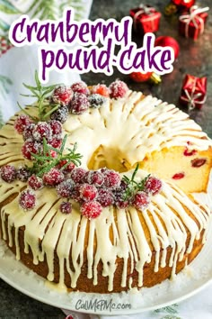 a cranberry pound cake with icing and berries on top, sitting on a plate