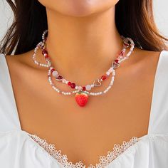 Discover Timeless Elegance Embrace the allure of sophistication with our Elegant Strawberry Heart Pearl Choker Necklace. Perfectly crafted to enhance your wardrobe for any occasion, this necklace combines the timeless elegance of imitation pearls with a touch of modern charm. Whether you're attending a wedding, a party, or simply looking for a special accessory for a romantic evening, this necklace is designed to dazzle. Product Features Our necklace is meticulously made with high-quality materials including baroque-style simulated pearls, vibrant acrylic accents, and shimmering crystals, all set in a durable iron alloy chain. The enchanting strawberry and heart-shaped pendant adds a unique, eye-catching element to this exquisite piece. Material Composition: Imitation pearl, acrylic, alloy Strawberry Necklace, Choker Designs, Y2k Necklace, Sweet Necklace, Pearl Chain Necklace, Aesthetic Jewelry, Heart Choker, Pearl Choker Necklace, Pearl Choker