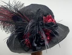 Victorian Hat Black with Plum #1114 This gorgeous Victorian style hat has a crochet Toyo hat frame with wired edge 3"-inch-wide brim. It is black with various shades of burgundy accents. There is a black lace band around the crown, black lace covering the crown, black and burgundy flowers, black lace bow, ostrich feathers and ostrich plume and peacock feather.  The brim is 3" inches and has a wire going around the edge of the brim so you can shape the brim pushing it up a bit higher on one side Black Brimmed Mini Hats For Garden Party, Black Mini Hat With Curved Brim For Garden Party, Gatsby Mini Hat For Kentucky Derby, Adjustable Straw Bucket Hat For Party, Adjustable Straw Bucket Hat For Parties, Whimsical Black Hat With Short Brim, Handmade Black Hat For Kentucky Derby, Handmade Mini Hat For Kentucky Derby Evening, Bohemian Party Costume Hat With Short Brim