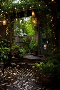 an outdoor patio with lots of plants and lights