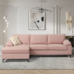 a living room with a pink sectional couch