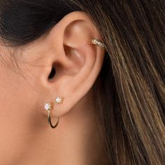 "Minimal with an edge, these stud earrings are the perfect subtle accent to your everyday ear stack. They utilize only one curve, making them more versatile since they can be worn like a stud to hug the lower part of the earlobe, but can also be flipped for an edgier look to curve over the inner ear. * D E T A I L S * ∙ Sold as a PAIR ∙ Material: .925 Sterling Silver or 18K Gold Plated over .925 Sterling Silver ∙ Stone: White Zirconia ∙ Dimensions: Height: 15mm // Zirconia: 4mm ∙ Hypoallergenic Suspender Earrings, Ear Lobe Piercings, Types Of Ear Piercings, Dainty Gold Earrings, Cool Ear Piercings, Cool Piercings, Inner Ear, Cute Piercings, Moon Studs