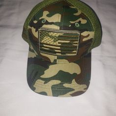 Show Off Your American Pride With This Usa Baseball Cap. The Hat Features An American Flag And Army Design With A Camouflage Green Color. It Is Made Of Polyester Material With A Canvas Fabric Type And Mesh Back Feature, Making It Perfect For Summer And Outdoor Activities. This Baseball Cap Is Adjustable To Fit Any Head Size And Is Suitable For Casual Wear, Workwear, Or Sports. The Hat Is Designed For Men And Has A Classic Style With A Touch Of Patriotism, Making It An Ideal Accessory For Any Occ Camouflage Sports Cap, Green Military Baseball Cap With Flat Bill, Camouflage Baseball Cap With Visor, Green Military Style Baseball Cap With Flat Bill, Military Camouflage Trucker Hat For Sports, Military Style Camouflage Trucker Hat For Sports, Casual Camouflage Baseball Cap For Sports, Military Style Trucker Hat, One Size Fits Most, Military Style Trucker Hat One Size Fits Most