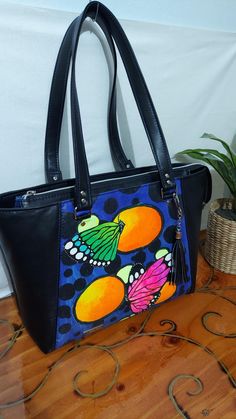 If you like this pattern, but don't like the fabric choices, please message me for a custom order! We can go over options and prices! The everyday tote bag is stylish with room for all 'the' things.  This bag is Neon Butterflies 🦋 hand-painted 🎨 and sealed with a vinyl gel coating, accented with soft black vinyl. The exterior back has a roomy zipper pocket and a top zipper that opens nice and wide. The interior is a waterproof canvas with a divided slip pocket and a zipper pocket. Measures 14w Everyday Butterfly Print Tote Bag, Hand Painted Tote Shoulder Bag For Daily Use, Hand Painted Tote Shoulder Bag For Everyday, Everyday Hand Painted Tote Shoulder Bag, Daily Use Hand Painted Tote Shoulder Bag, Everyday Rectangular Hand Painted Shoulder Bag, Handmade Black Canvas Bags, Everyday Rectangular Hand-painted Shoulder Bag, Daily Use Hand Painted Canvas Bags