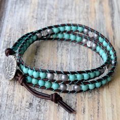 Genuine leather and turquoise Howlite stones make up this classic boho style, double wrap bracelet. Always a favorite for it's versatility and simplicity ~ and when you think bohemian, you think turquoise! This wrap includes pretty matte silver hematite and sparkly clear crystal accents. Turquoise looks gorgeous on every skin tone. Give it a try and enjoy the versatility. 4mm (.157") diameter turquoise Howlite gemstones Silver finished tea leaves motif button, about 15mm (.59") in diameter Ombre Turquoise Hand Wrapped Wrap Bracelet, Classic Boho Style, Turquoise Wrap Bracelet, Beaded Leather Wraps, Boho Wrap Bracelet, Double Wrap Bracelet, Howlite Stone, Beaded Wrap Bracelets, Beaded Wraps