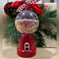 a candy dispenser sitting on top of a table next to a christmas tree