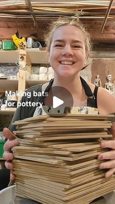 a woman is holding stacks of wood in front of her face and the words making bats for pottery