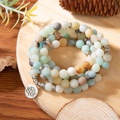 Amazonite is a soothing stone. Wear it and you will immediately feel a sense of inner peace and balance. It possesses a powerful energy, like the river of which it bears the name, but it is nevertheless capable of taming and calming negativity and anger.This splendid Mala bracelet is carefully handmade with 108 natural genuine matte Amazonite and Rodhonite gemstone beads. It can be worn as a bracelet, necklace or used for meditation. Length is about 23.6 inches (60 cm) and is elastic. 3 charms a Spiritual Gemstone Beaded Bracelets For Meditation, Agate Meditation Bracelets With 108 Beads, Agate Bracelets With 108 Beads For Meditation, Meditation Bracelets With 8mm Beads, Holistic Beaded Bracelets With Round Beads For Meditation, Bohemian Beaded Bracelets For Meditation, Holistic Agate Jewelry With 108 Beads, Agate Beaded Bracelets With 108 Beads For Meditation, Spiritual Round Beaded Bracelets For Meditation