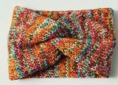 a multicolored knitted scarf with a knot