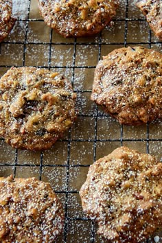 several cookies on a cooling rack covered in powdered sugar