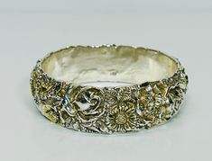 Vintage Repousse Sterling Silver Bangle Stamped 925 Ornate Thick Silver Bangle Up for sale is this gorgeous repousse sterling silver bangle, stamped 925. It is one inch wide, with a circumference measured from the inside of 8 1/2 inches (2 5/8 inches diameter.) Stunning ornate design, some of the flowers have gold gilt to add dimension to the piece. It weighs 33 grams. Very good condition as you can see from the photos. Please see the photos and the video for a more detailed description of this Ornate Design, Sterling Silver Bangle, Sterling Silver Bangles, Silver Bangle, One Inch, Silver Bangles, Bangle Bracelets, Jewelry Bracelets, Etsy Accessories